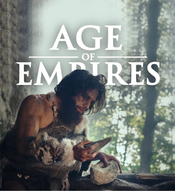 Age of Empires logo with an actor in the foreground wearing caveman like attire