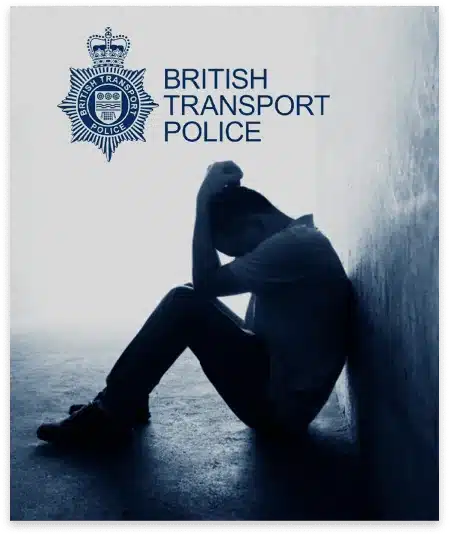 A Silhouette Of A Person Sitting On The Ground With Their Back Against A Wall, Head Lowered And Hands Clasped Over Their Head. The British Transport Police Logo And Title Appear Above Them, Representing The Vigilance Of The Dragonfly Team. The Image Conveys A Sense Of Distress Or Contemplation. A silhouette of a person sitting on the ground with their back against a wall, head lowered and hands clasped over their head. The British Transport Police logo and title appear above them, representing the vigilance of the Dragonfly Team. The image conveys a sense of distress or contemplation.