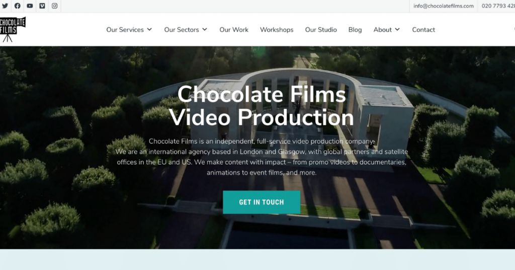 Website Homepage Of Chocolate Films Video Production, One Of The Top 10 Video Production Companies, Showcasing Services In Film Production With An Aerial View Of An Elegant Building In A Green Landscape. Includes A Navigation Menu, Contact Information, And A Green &Quot;Get In Touch&Quot; Button. Website homepage of Chocolate Films Video Production, one of the top 10 video production companies, showcasing services in film production with an aerial view of an elegant building in a green landscape. Includes a navigation menu, contact information, and a green "Get in Touch" button.