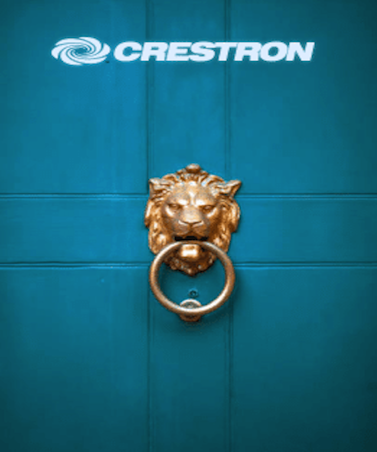 A blue door with a gold lion head door knocker in the center. Above it, the logo of Crestron stands out, featuring "CRESTRON" in white uppercase letters and an abstract circular design. The scene exudes an air of professionalism, perfect for a corporate video production setting.