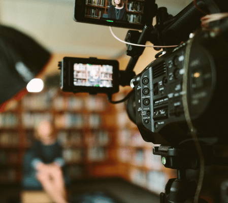 Filming a talking heads video in a library with Dragonfly video productions