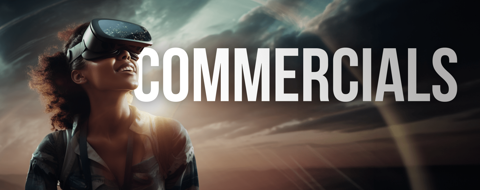 A person wearing a virtual reality headset looks upwards with a smile against a dramatic sky backdrop. The word "COMMERCIALS" is prominently displayed in bold white letters across the sky.