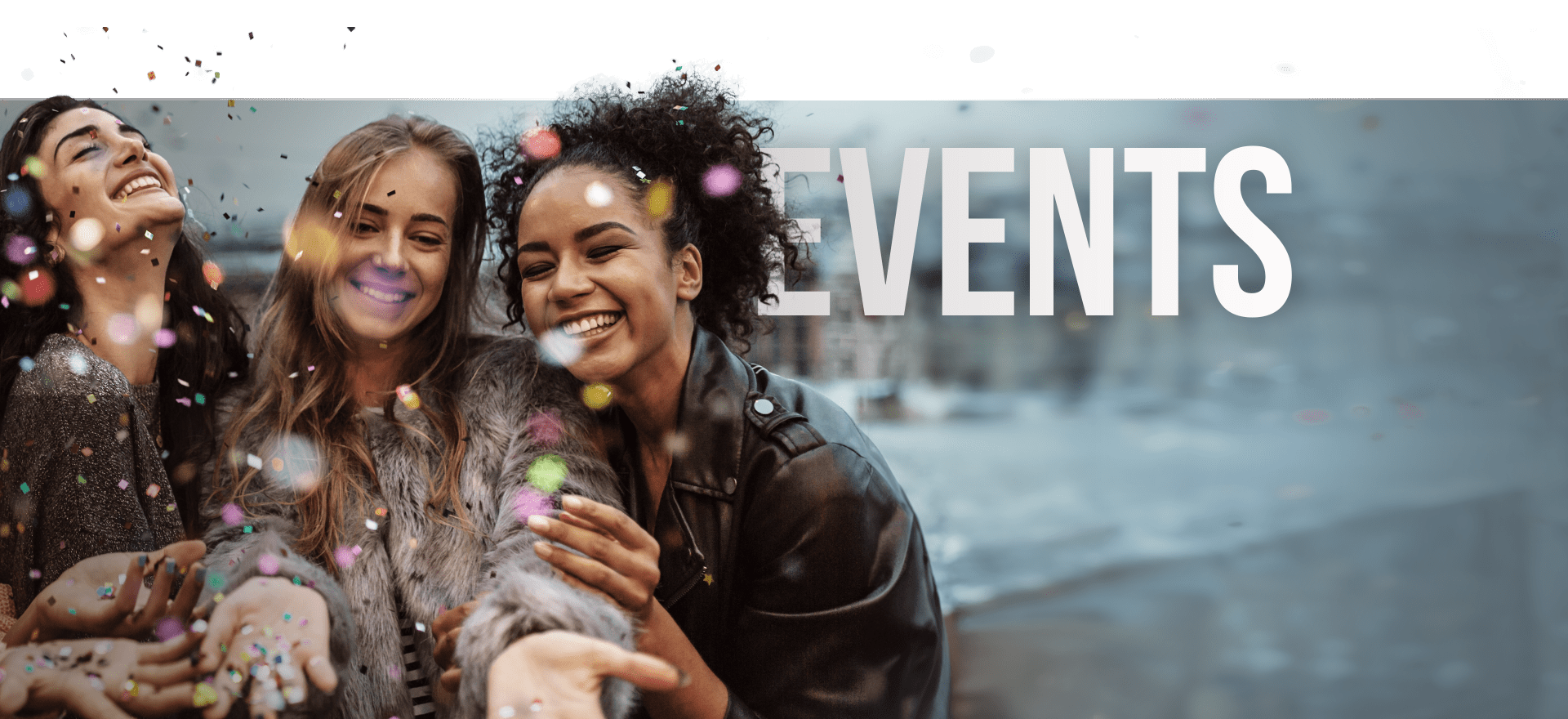 Three Smiling Individuals Stand Outdoors In A Joyful Moment, Surrounded By Falling Confetti. They Are Close Together, Posing For A Selfie With A Blurred Urban Background. The Word &Quot;Events&Quot; Is Prominently Displayed In Large White Text To The Right. Three smiling individuals stand outdoors in a joyful moment, surrounded by falling confetti. They are close together, posing for a selfie with a blurred urban background. The word "EVENTS" is prominently displayed in large white text to the right.